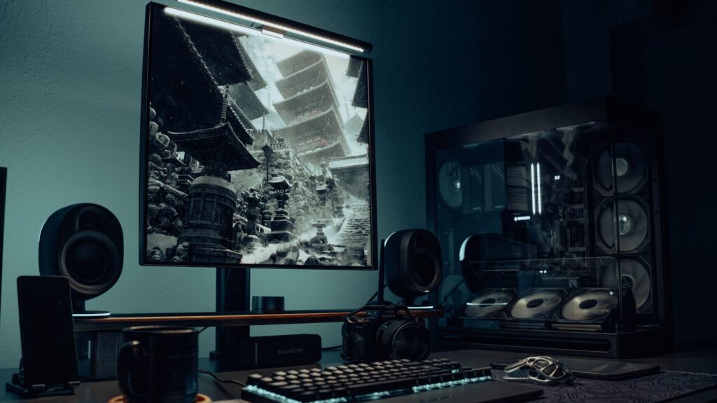 Dark 4K gaming desk setup with large monitor