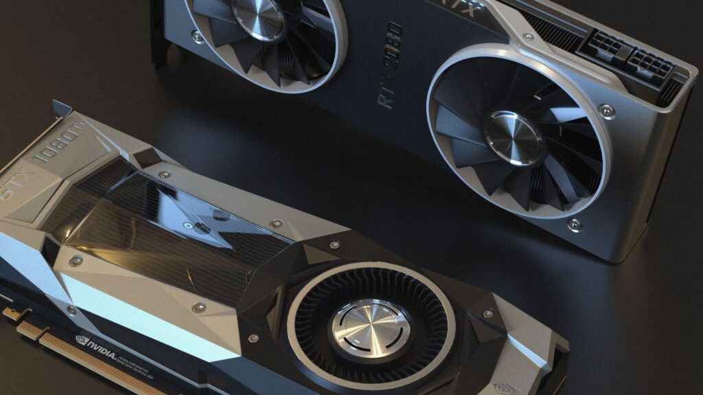 Two graphics cards on a dark desk