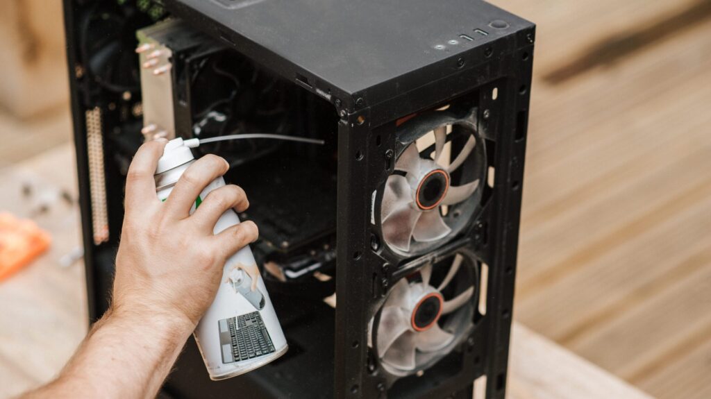 Cleaning a gaming PC case with compressed air Pexels