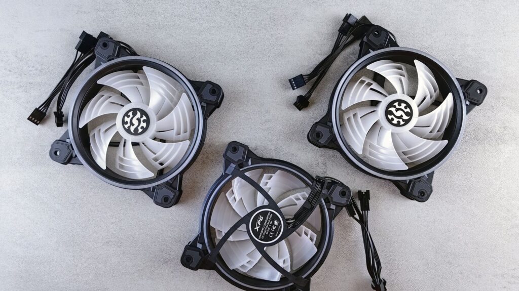 Three PC case fans on a workbench